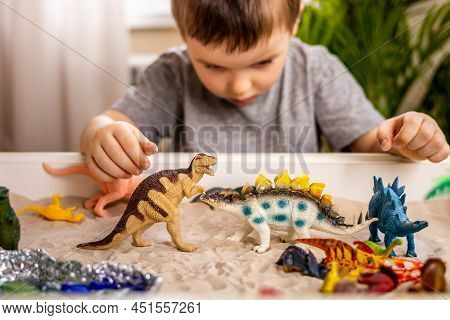 Confident Cute Baby Boy Playing Carnivorous And Herbivorous Dinosaurs Early Development Game
