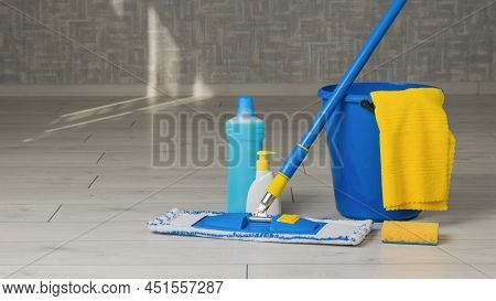 Yellow And Blue Cleaning Kit In The Room On The Wooden Floor. Home And Office Cleaning Kit. The Conc