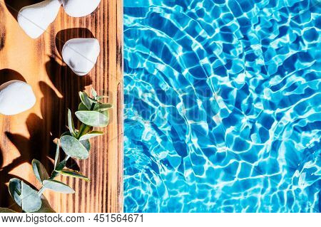 Wood Sand Board With Hot White Salt Stones And Twig Natural Eucalyptus. Blue Transparent Reflect Wav
