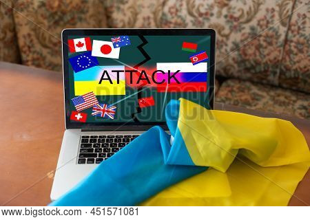Ukrainian And Russian Flag On A Tablet And Inscription Attack.