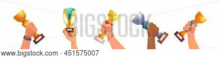 Winner Multiethnic Handsholding A Goblet In Hand, Idea Of Achievement, Leadership, Victory, Success.