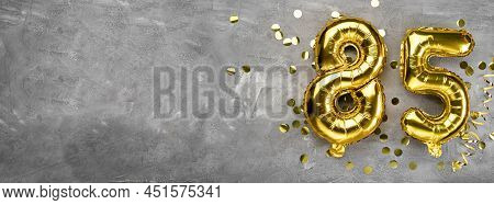 Yellow Foil Balloon Number, Number Eighty-five On A Concrete Background. Greeting Card With The Insc