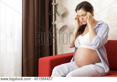Young And Pregnant Woman Has Painful Headache