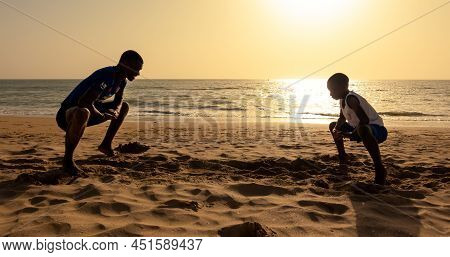 Saly, Mbour, Senegal - Circa December 2021. Unidentified Mature Man And Teenager, Father And Son, Do