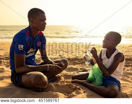 Saly, Mbour, Senegal - Circa December 2021. Unidentified Mature Man And Teenager, Father And Son, Do