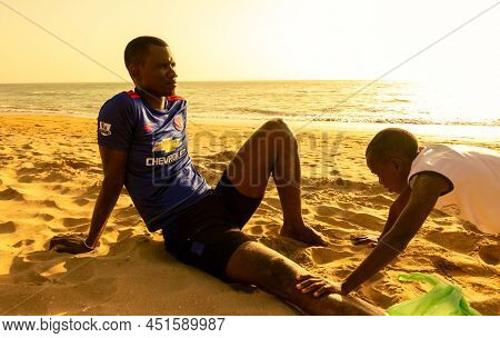 Saly, Mbour, Senegal - Circa December 2021. Unidentified Mature Man And Teenager, Father And Son, Do