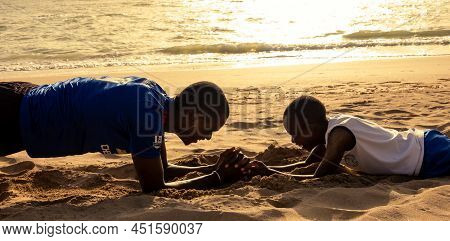 Saly, Mbour, Senegal - Circa December 2021. Unidentified Mature Man And Teenager, Father And Son, Do