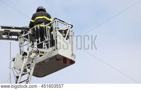 Brave Firefighter Who Saves The Injured Person Using The Truck With The Ladder Truck During An Emerg