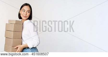 Portrait Of Young Asian Woman Holding Boxes, Carry Delivery Goods. Korean Female Entrepreneur Assemb