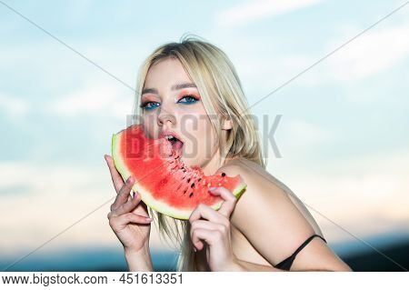 Sexy Summer Tropical Fruit. Closeup Portrait Of Young Blonde Sensual Woman Eating Watermelon.