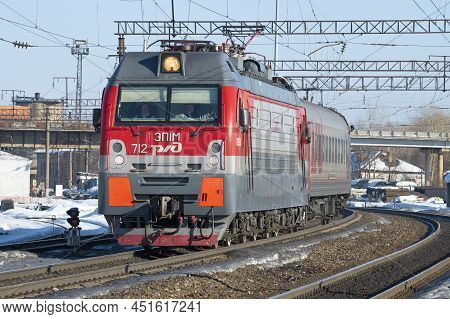 Sharya, Russia - March 18, 2022: Russian Modern Electric Locomotive Ep1m-712 With A Passenger Train 