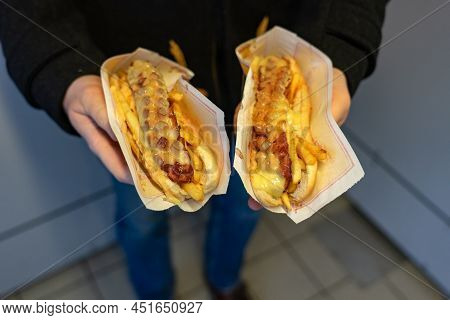 Man Holding Two Special Icelandic Hot Dogs