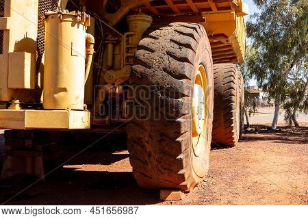 Newman, Western Australia - July 11, 2018: Detail Of A Giant Tyre Of Yellow Wabco Haulpak Truck In N