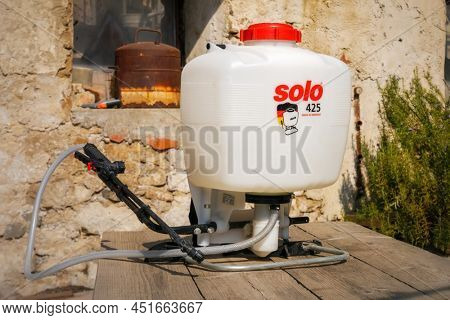 Ihringen, Baden Wuerttemberg, Germany - March 26, 2022: Backpack sprayer Solo 425 on a wooden table in the backyard.