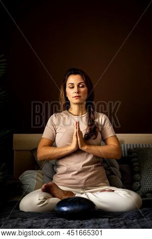 Relaxed Yoga Woman Meditation In Lotus Position With Hands Namaste On Bed At Bedroom