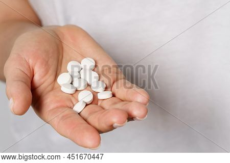 Female Hand With A Handful Of Pills