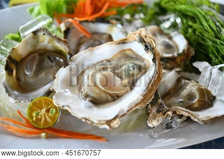Fresh Oysters With Lime And Vegetable On Plate. Oyster Season. Macro-seafood Dish. The Zinc Mineral 