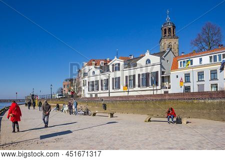 Deventer, Netherlands - March 03, 2022: People Walking The Promenade Along The Ijssel River In Deven