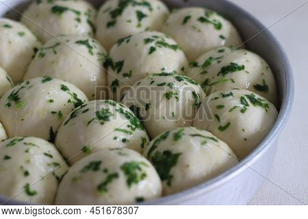Dinner Rolls Dough Ready To Go To The Oven Prepared In A Circular Bake Tin. Glazed With Butter And C