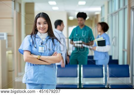 Medical Woman Student Wear Blue Uniform Hang Stethoscope Arms Crossed Smiling Looking At Camera Stan