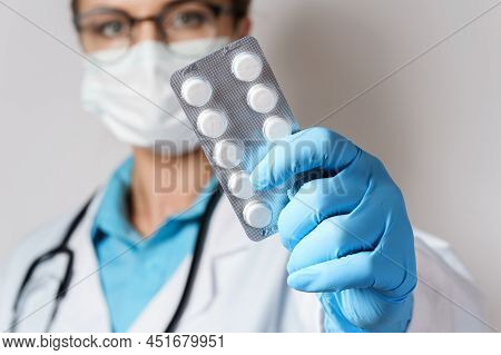 Female Doctor And Pills In Foil Packaging