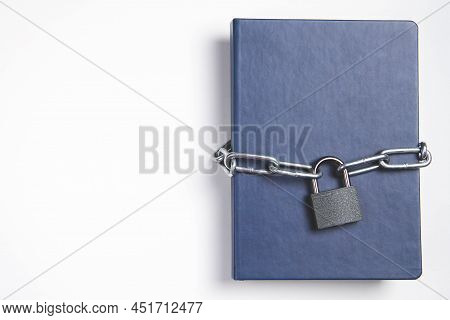 The Book Is Locked Under Lock And Key On A White Background. Secret Archive. Chain On The Book Close