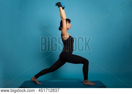 Active Atheltic Person Streching Body Muscles Practicing Fitness Workout Using Dumbbells Working At 