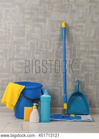 Cleaning Kit Near The Wall In The Room On The Floor. Home And Office Cleaning Kit. The Concept Of Ma