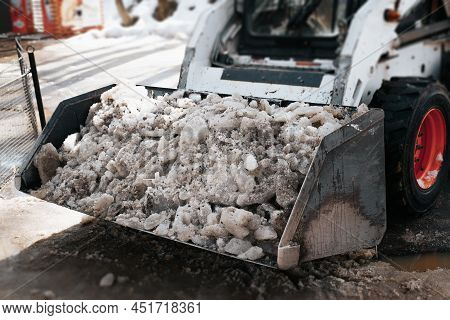 Minitractor, Small Bulldozer Clearing Snow On Street Outdoors, Close-up. Selective Focus On Snow And