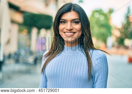 Beautiful hispanic woman smiling confient at the city