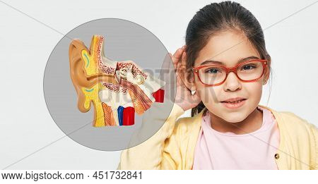 Hearing Problems In Children And Treatment Of Deafness. Little Girl Holds Hand Near Her Ear For List
