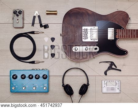 Flat Lay With Electric Guitar And Accessories On The Light Wooden Floor