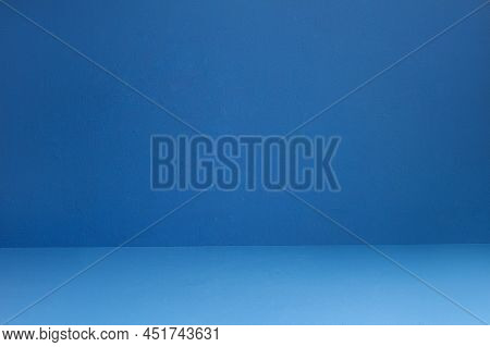 Blue textured wall and floor with some small white spots and dirt. Artistic painted background. Abstract art with copy space.