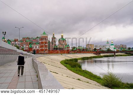 Yoshkar-ola. Russia. A Man Walks Along Voskresenskaya Embankment. View Of The Museum Of Orthodoxy An