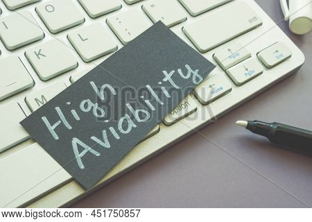 A Sheet Of Paper With Words High Availability Lies On The Keyboard.