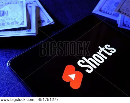 Kyiv, Ukraine - March 20, 2022. Youtube Shorts Logo And Money As A Symbol Of Monetization.