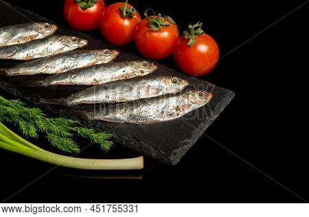 Spicy Sprat With Vegetables On A Serving Board. Small Salted Fish With Vegetables. Delicious Ideas F