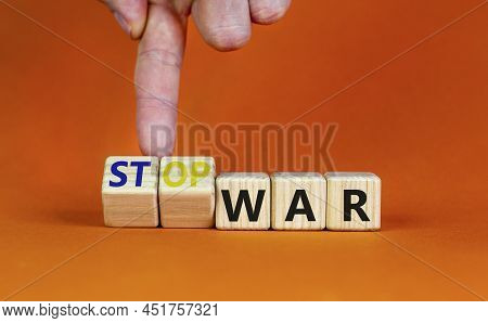 Stop War Symbol. Businessman Turns Cubes And Changes Concept Words War To Stop War. Beautiful Orange