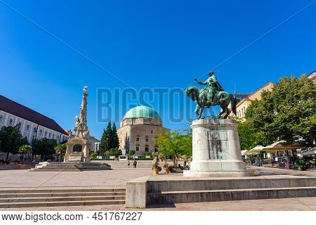 The Beautiful Main Square Of Pecs Hungary With Dzsami Mosque And Statues