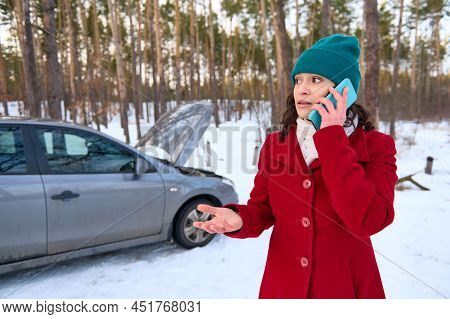 Frustrated Caucasian Woman Driver Talks On Mobile Phone, Calls Roadside Assistance Standing In A Sno