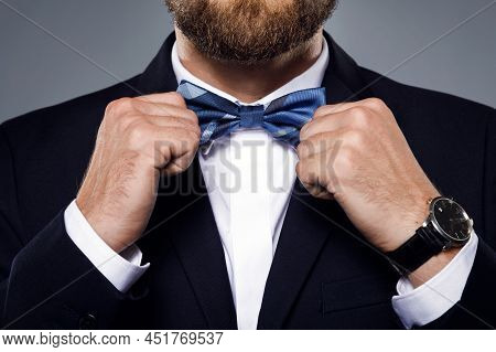 Man Is Fiting Up A Beautiful Bow Tie