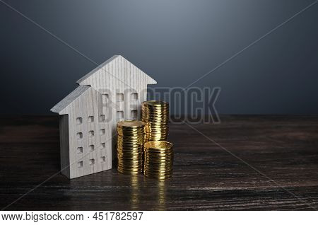 Apartment Buildings And Money Coins. Profit From Investment In Real Estate. Maintenance And Repair. 