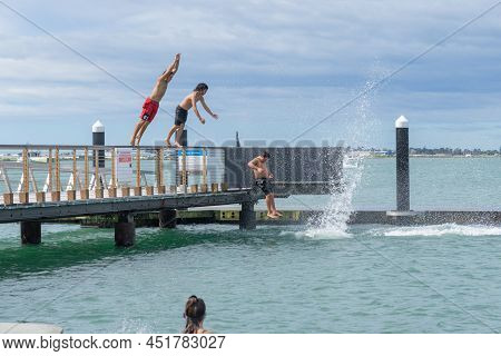 Tauranga New Zealand March 26 2022;boys Enjoy Jumping Of Pier And Diving Platform On City Waterfront