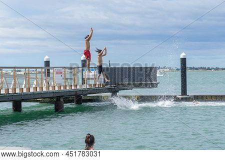 Tauranga New Zealand March 26 2022;boys Enjoy Jumping Of Pier And Diving Platform On City Waterfront