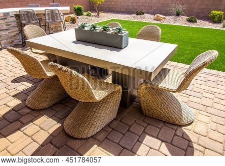Pavers Patio With Table And Six Unique Wicker Chairs