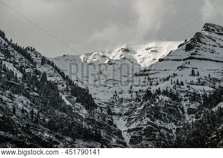 A Snow Covered Mountain Peak At Day