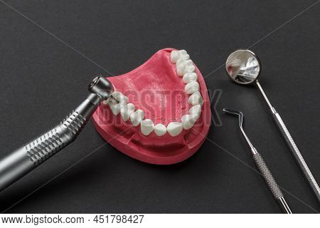 Head Of High-speed Dental Handpiece With Bur, A Mouth Mirror, A Dental Restoration Instrument And A 