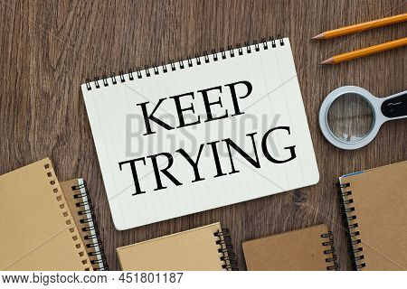Keep Trying Text On Open Notepad On Wooden Background