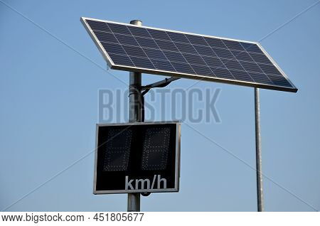 Radar To Measure The Speed Of Vehicles In The City. A Reflective Green Sign On A Pole With Led Light