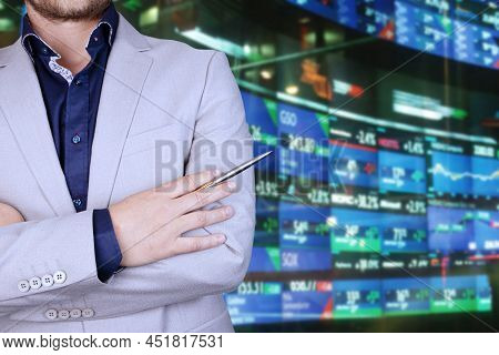 Businessman, Broker Analyzing Stock Market Changes, Falling And Rising Numbers And Lines On The Char